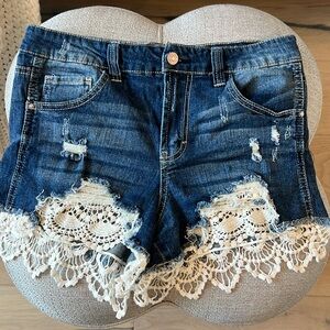 Denim shorts with distressing and lace trim